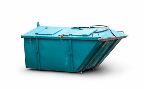Enclosed skip being loaded with construction debris